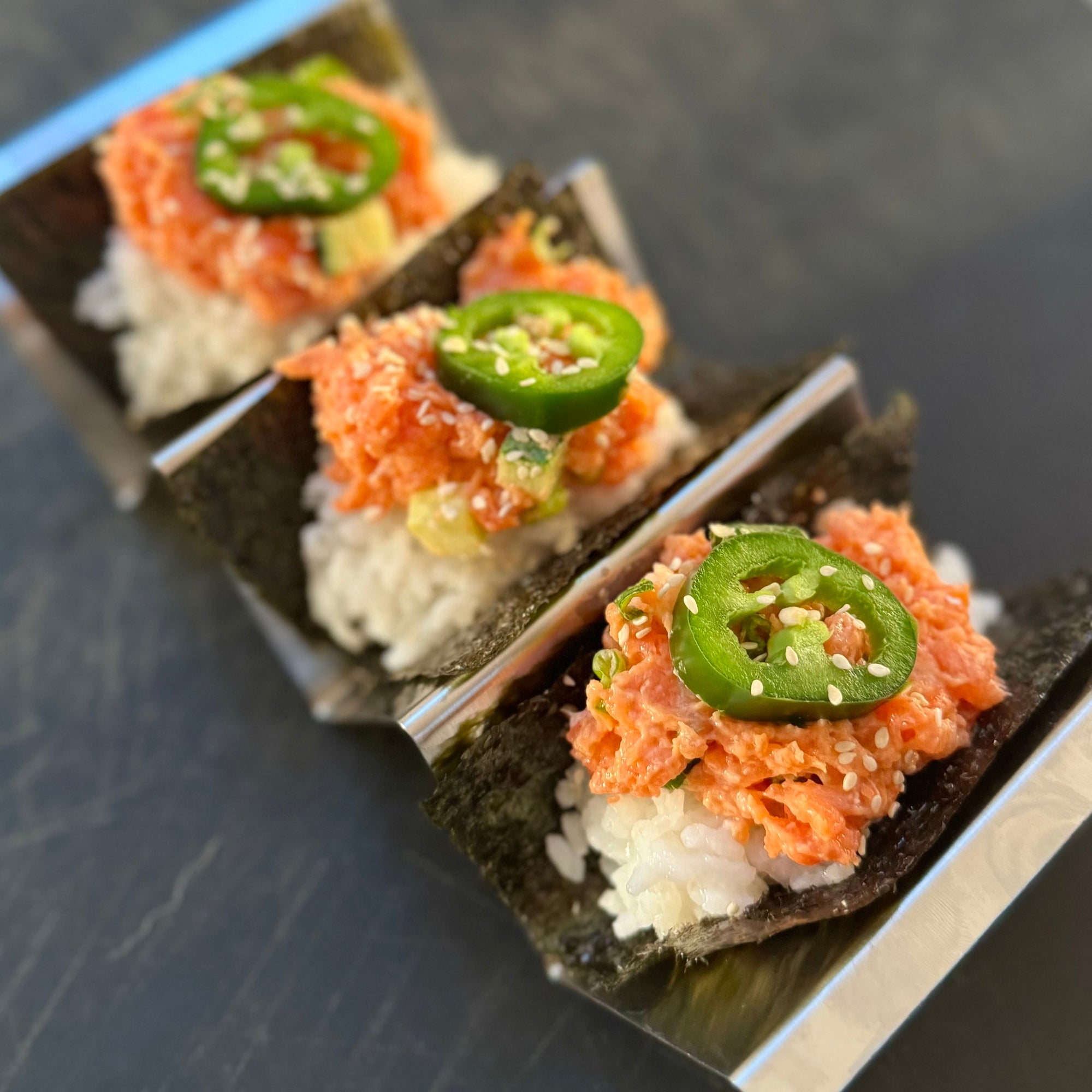 spicy salmon sushi tacos with jalapeno slice ready to eat