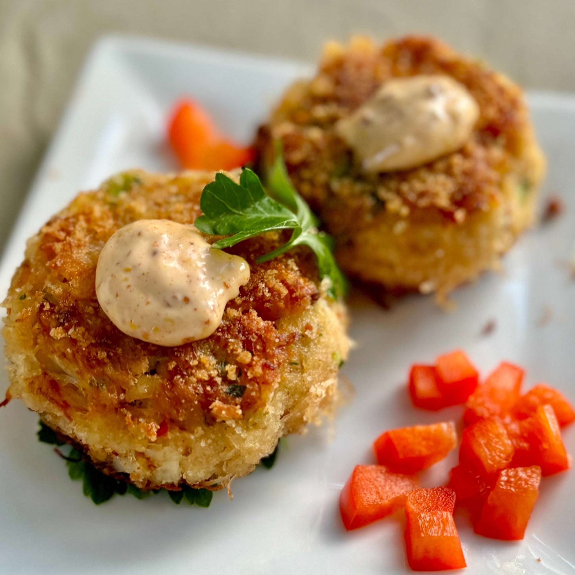 delicious crab cakes with spicy remoulade sauce on top