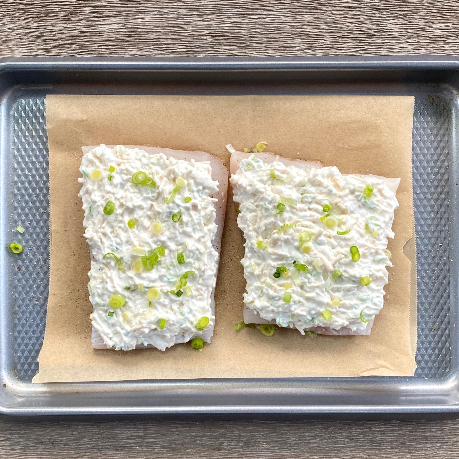Beautifully plated holiday halibut, garnished with fresh herbs and lemon slices, served as the centerpiece for a festive holiday dinner.
