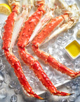 Jumbo Alaskan Red King Crab Legs on a bed of ice with butter and lemon.