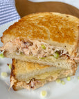 Dungeness crab meat grilled cheese sandwich on a plate.