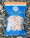 Package of wild Gulf shrimp on pebbles