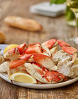 dungeness crab legs on plate with lemon wedges