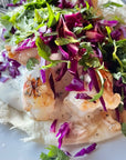Spot prawn taco topped with wild Alaskan spot prawns and fresh cabbage slaw