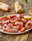 wild Alaskan spot prawns served on a platter with lemon and bread