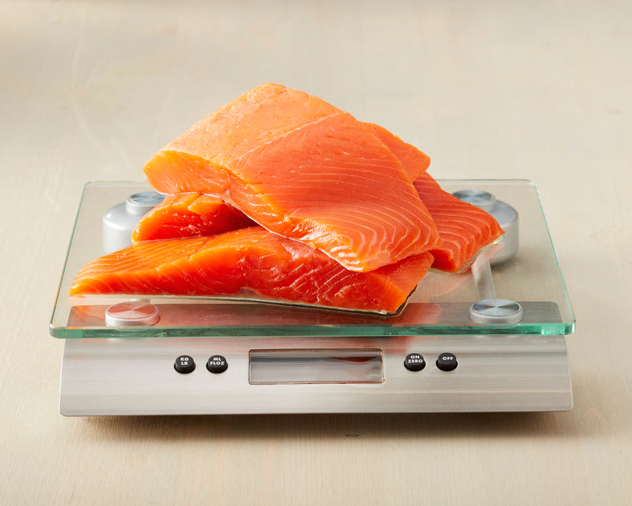 portions of king salmon on a scale