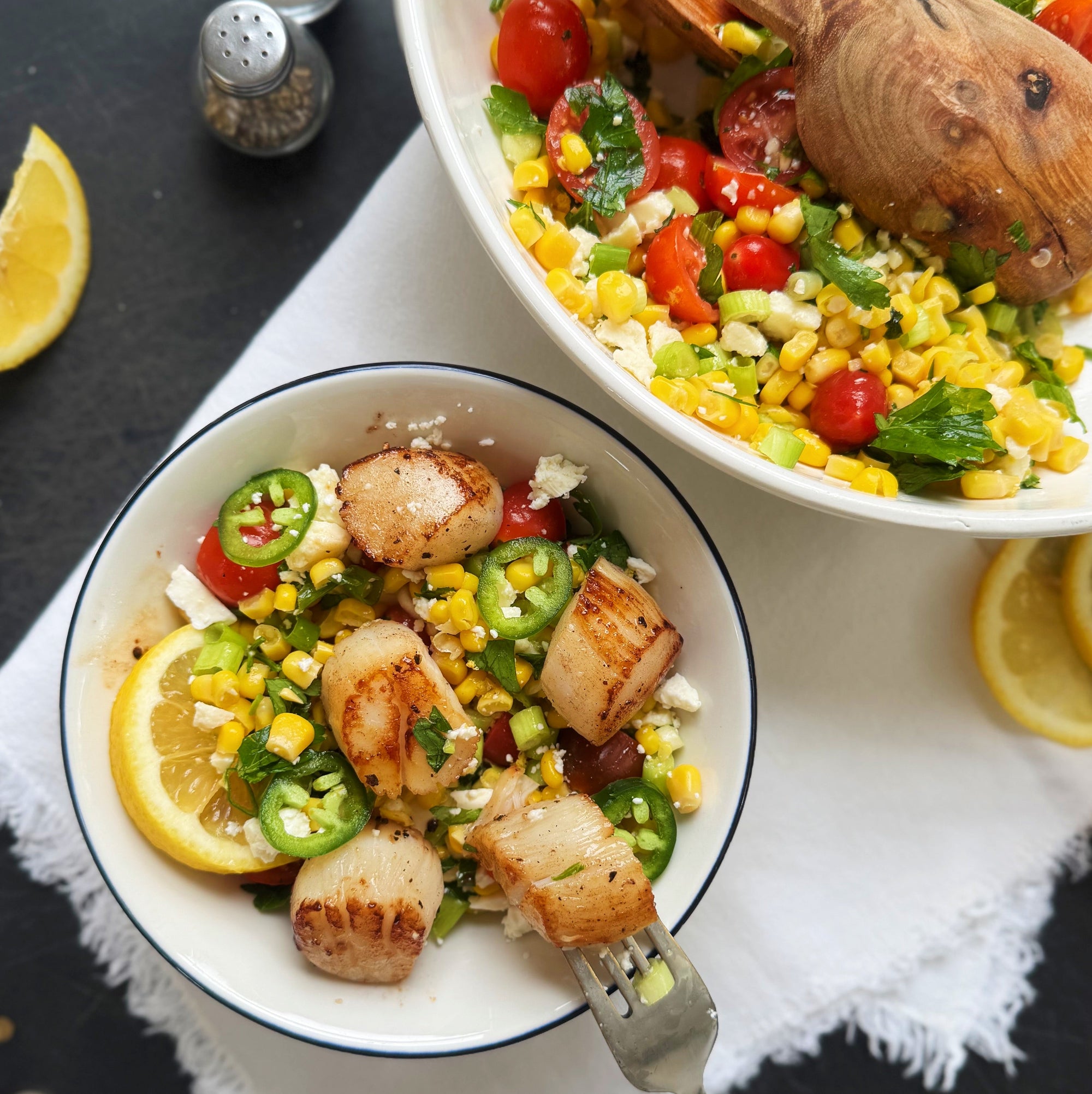 seared scallops with tomato and corn salad in a bowl