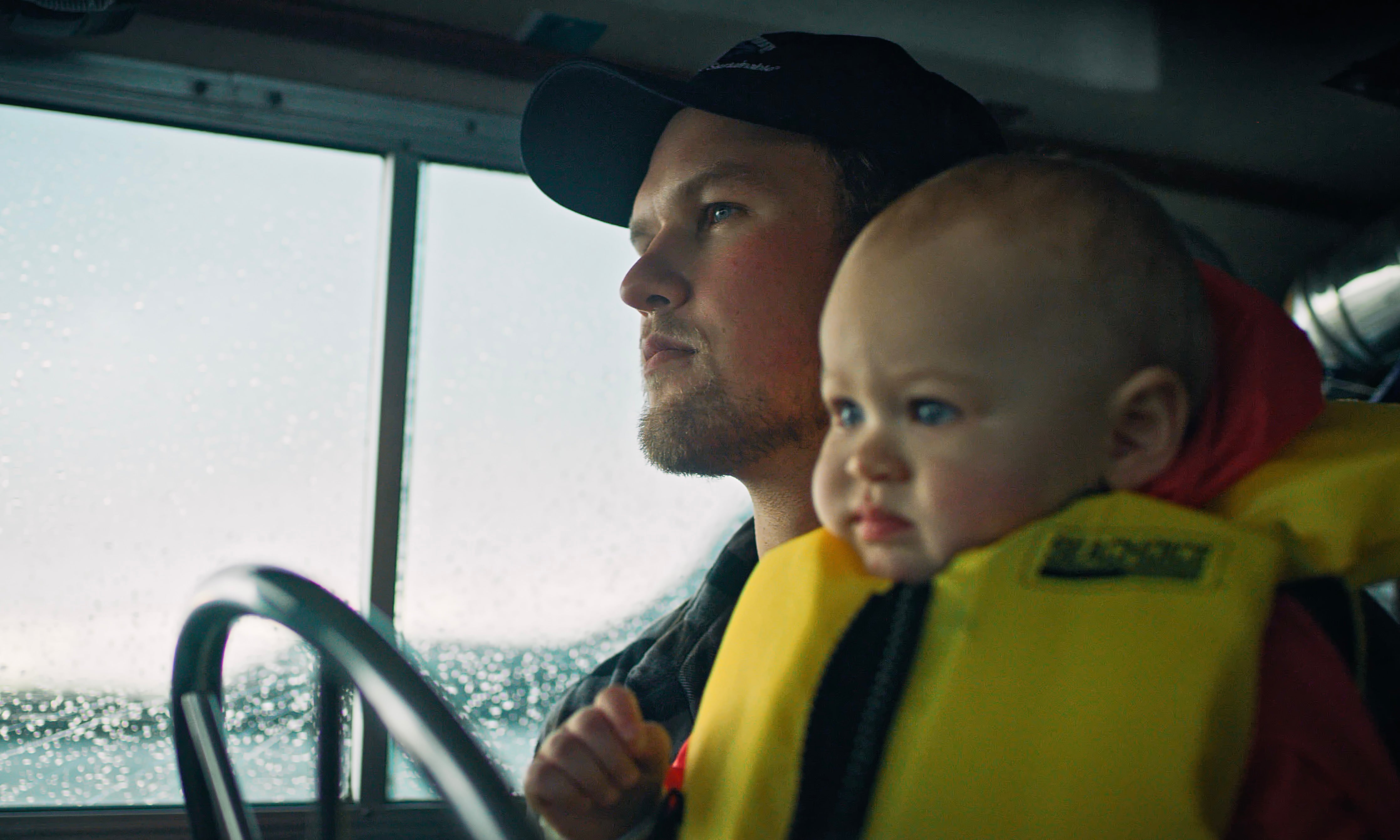 Man holding baby considering seafood for ED, infertility, and low sperm count.