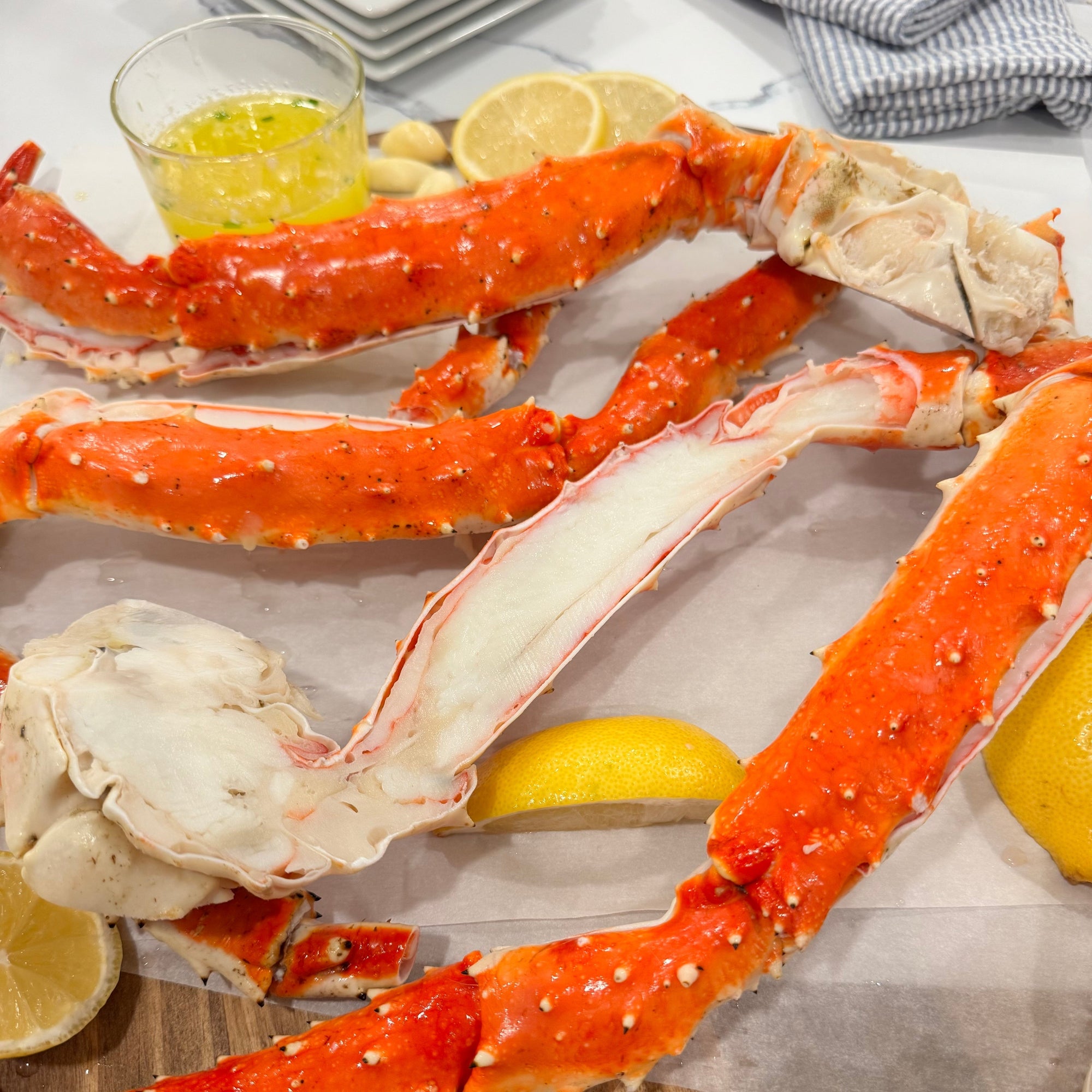 alaskan red king crab with melted butter and lemon slices