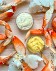 Wild Alaskan Dungeness crab legs arranged with dipping sauces