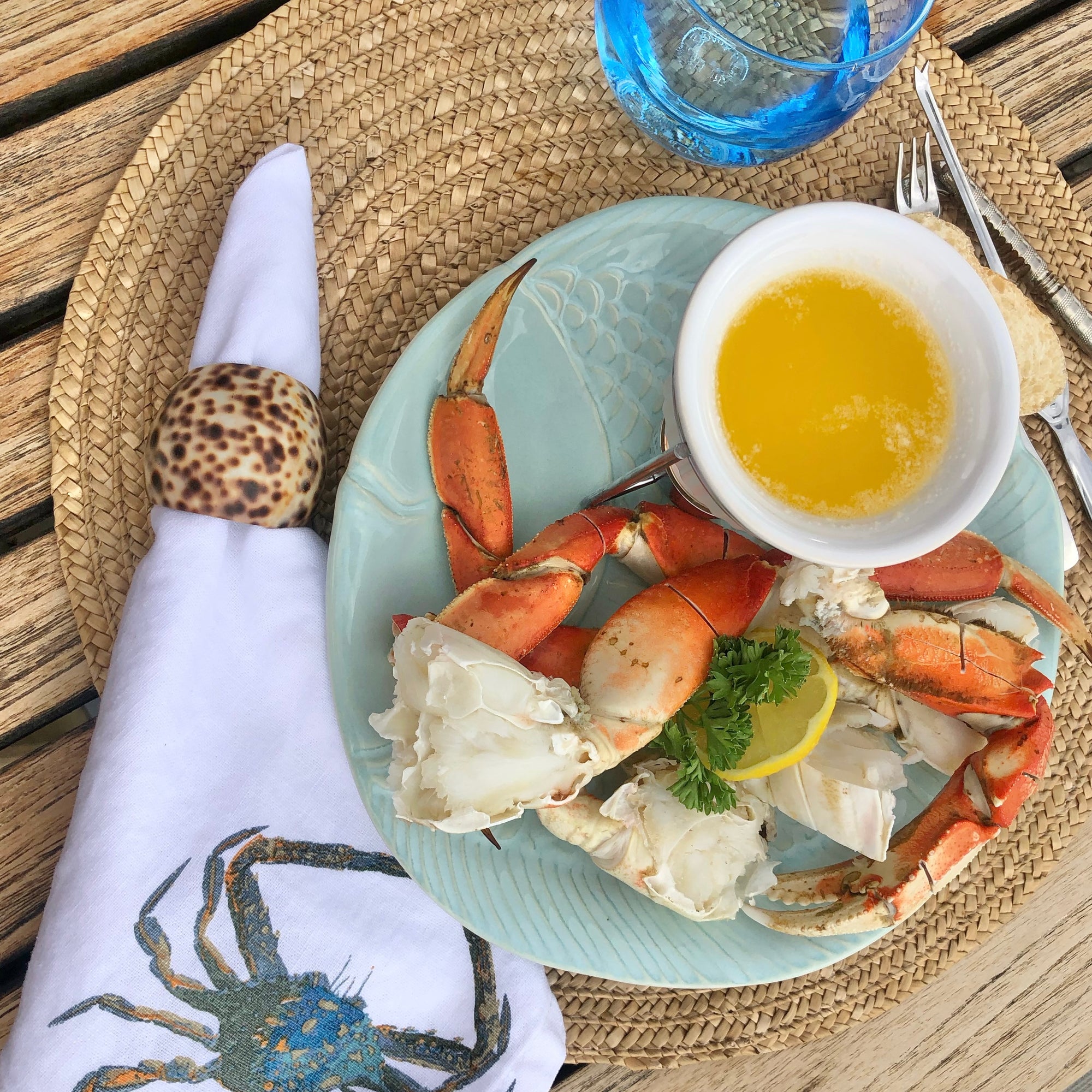 Wild Alaskan Dungeness crab served with melted butter on a table setting
