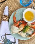 Wild Alaskan Dungeness crab served with melted butter on a table setting