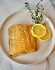 Wild Alaska smoked sablefish fillet plated with lemon slices